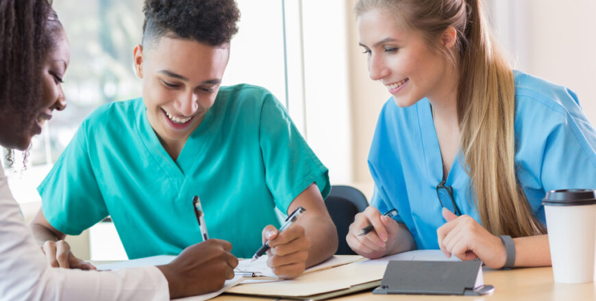 Cheerful diverse medical students study together